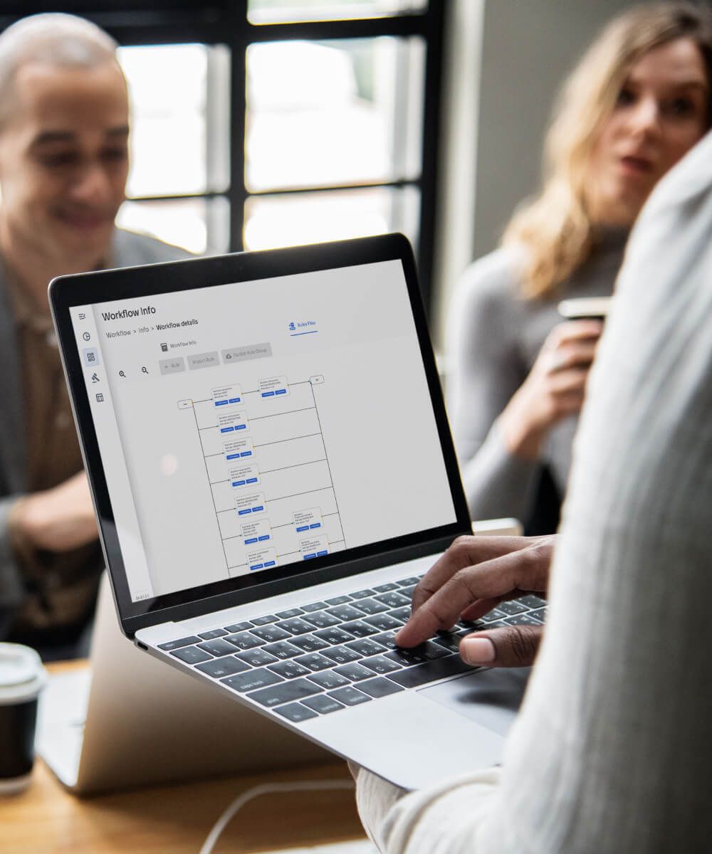 Workflow screen on laptop showing process diagram during a team meeting - Neutrinos