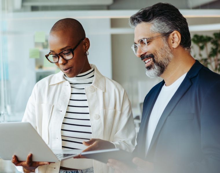 Two professionals discussing work while viewing a laptop screen-Neutrinos