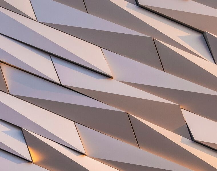 Geometric architectural pattern with angular metallic panels and warm lighting accents-Neutrinos