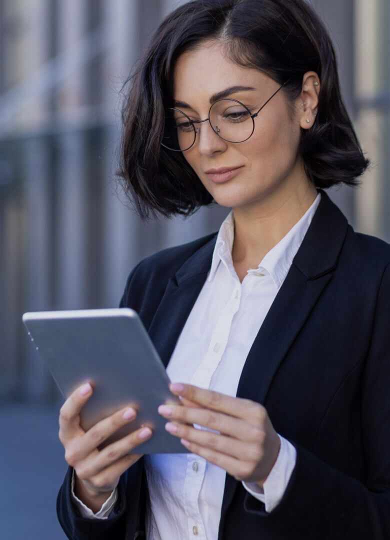 Professional woman using a tablet device outside an office building-Neutrinos