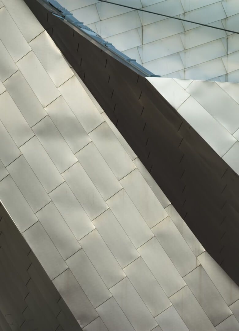 Close-up of an architectural surface with overlapping woven-patterned panels in neutral tones- Neutrinos