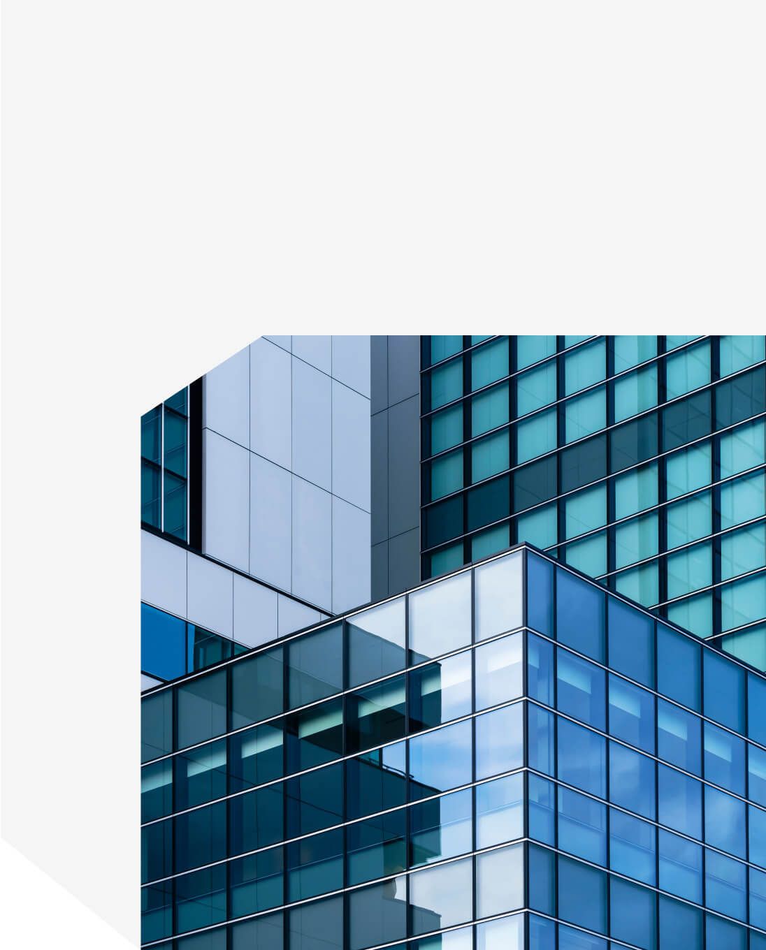 Modern glass facade of a commercial office building with reflective blue windows - Neutrinos