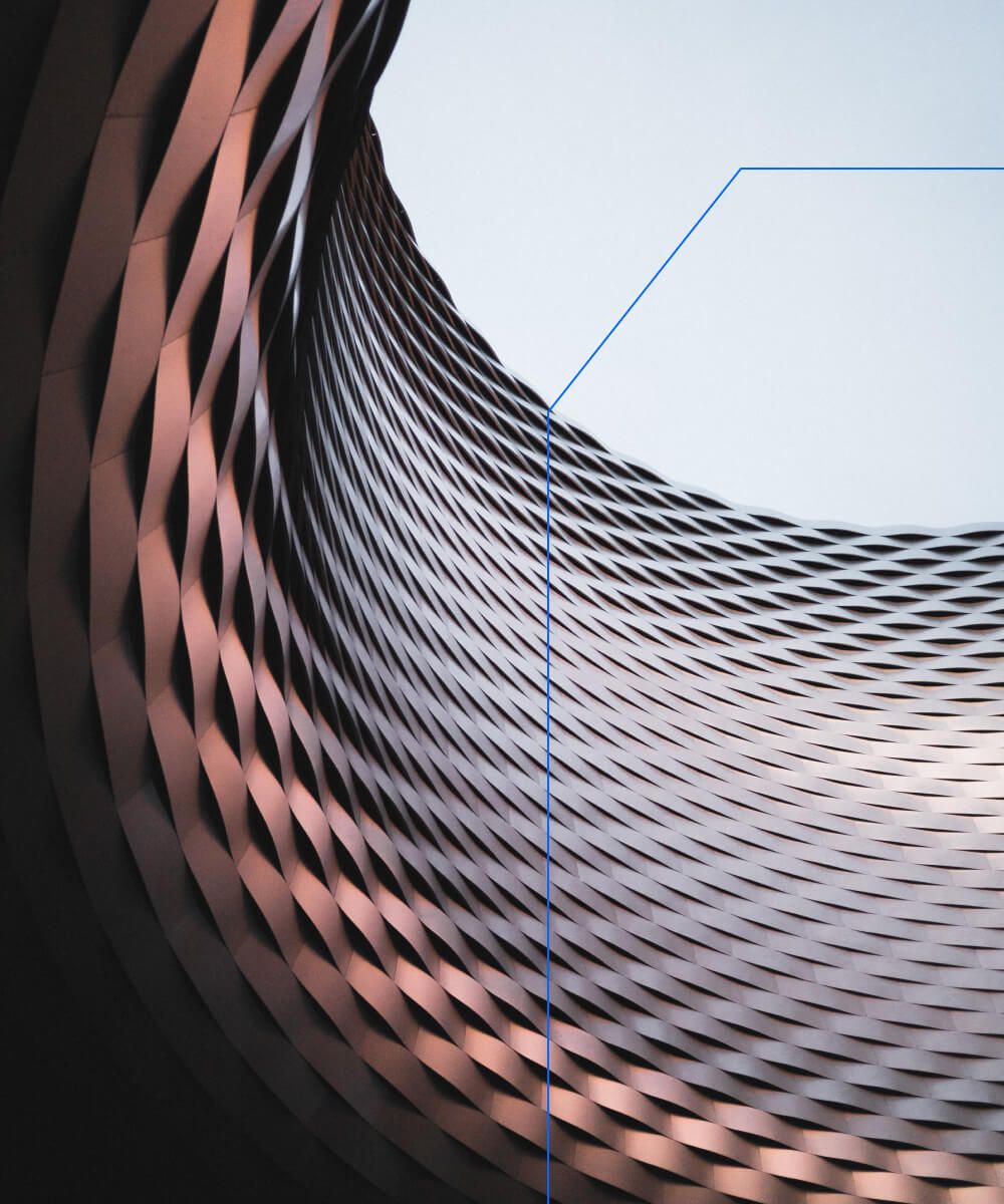 Curved metallic facade with a twisted mesh design, highlighting modern architectural patterns - Neutrinos