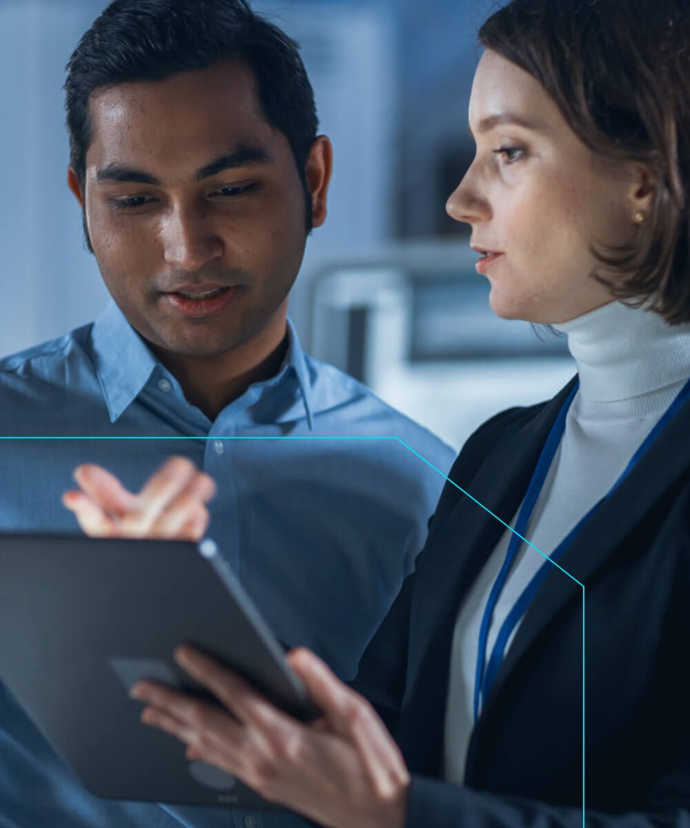 Two professionals reviewing information on a tablet in a modern office setting- Neutrinos