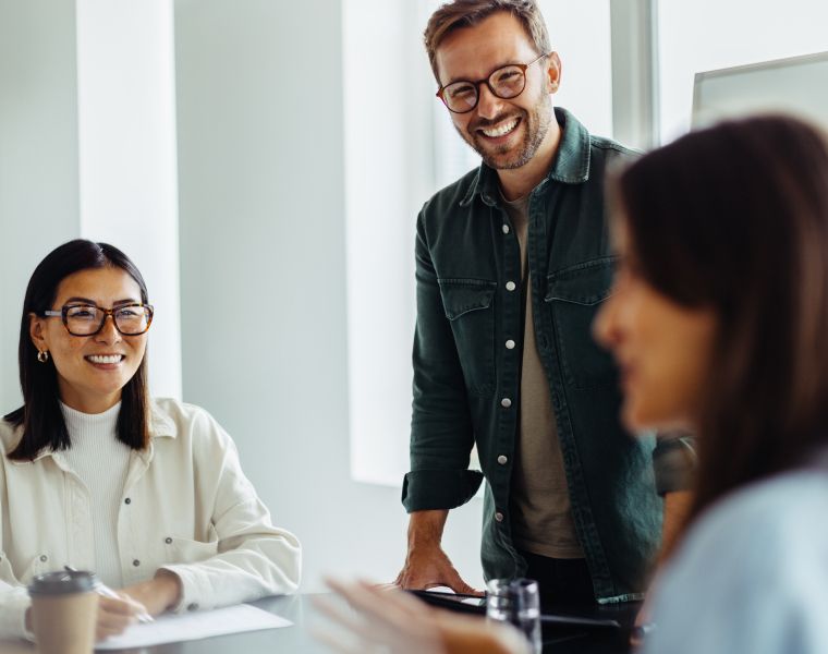 Happy professionals collaborating during a team meeting-Neutrinos