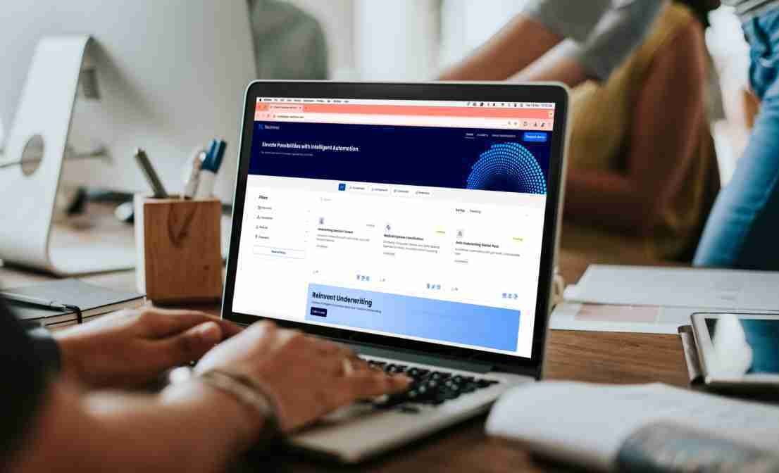 User browsing Neutrinos’ intelligent automation marketplace on a laptop in a collaborative workspace – Neutrinos
