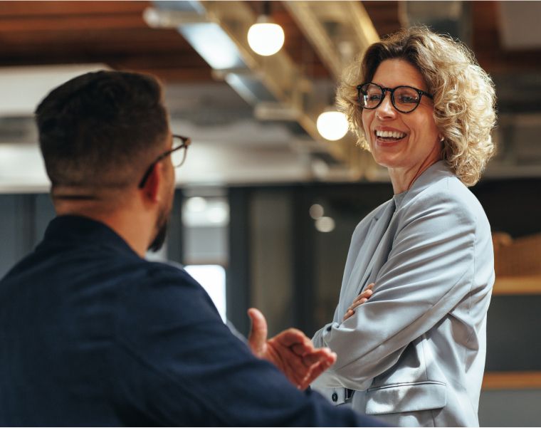 Two professionals having a cheerful conversation in a modern office setting-Neutrinos