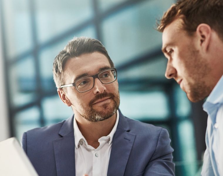 Two professionals having a focused conversation in a modern office setting-Neutrinos