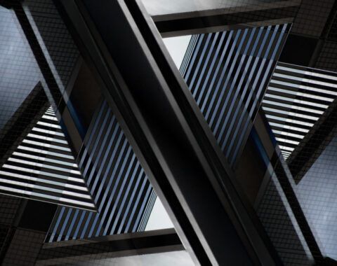 Abstract architectural pattern formed by reflections of modern glass skyscrapers with geometric lines and angles - Neutrinos