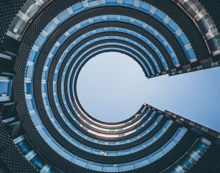 Upward view of a modern circular building with open sky at the center- Neutrinos